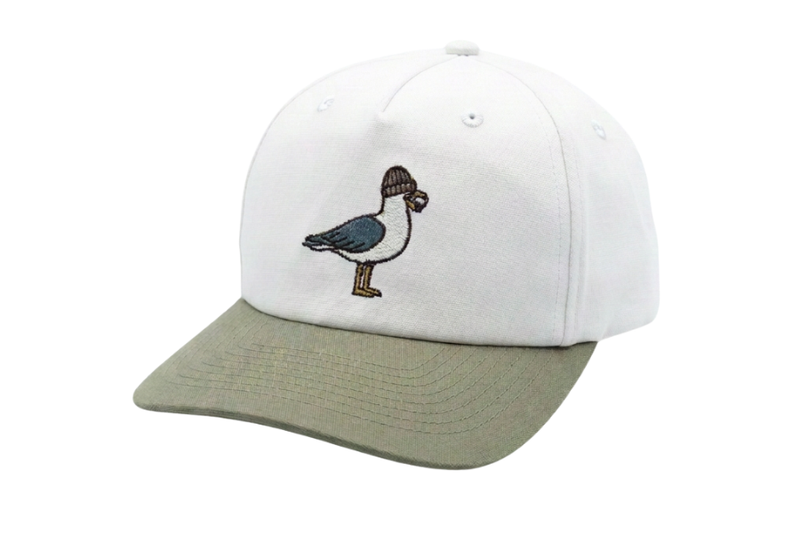 A structured baseball cap with a white crown and an olive green curved brim, featuring an embroidered bird design on the front.
